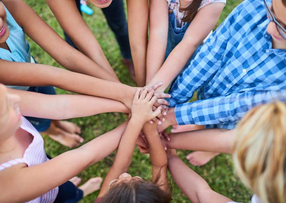 kindness-is-power-cropped-shot-of-a-group-of-kids-stacking-their-hands-on-top-of-each-other